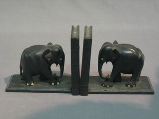A pair of ebony book ends in the form of walking elephants