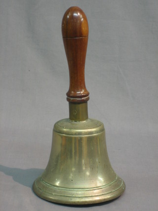 A brass hand bell with turned mahogany handle