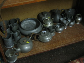 3 various pewter tea pots, a lozenge shaped caddy 6", a Victorian pewter pint tankard, marked Windsor Castle Sutton, a 19th Century pewter half pint tankard with glass base, 4 other tankards a circular Craftsman planished pewter bowl raised on 3 outswept feet 10" and other pewter items