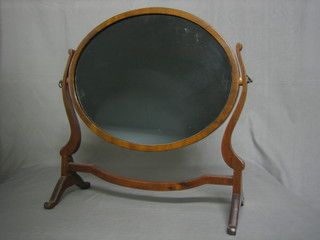 A 19th Century oval plate dressing table mirror contained in a mahogany swing frame 17"