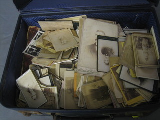 A blue fibre suitcase containing a large collection of various old photographs