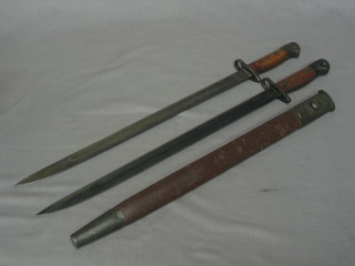 A 1907 Wilkinson bayonet and scabbard and 1 other (no scabbard and f)