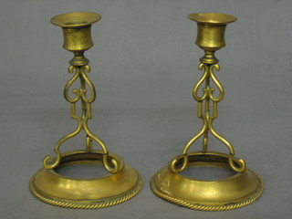 A pair of 19th Century circular gilt metal candlesticks with capital sconces 7"