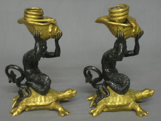 A handsome pair of 19th/20th Century Regency style bronze and gilt ormolu candlesticks in the form of a Mermen on turtles 7"