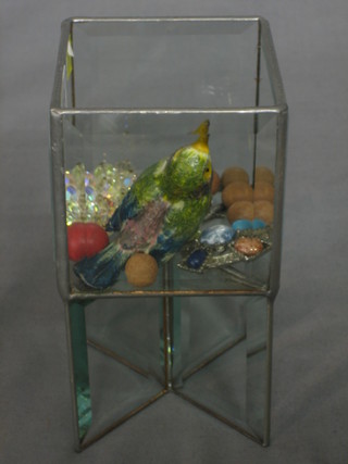 A painted metal figure of a bird 2", a small collection of marbles and 2 brooches contained in a glass and lead planter