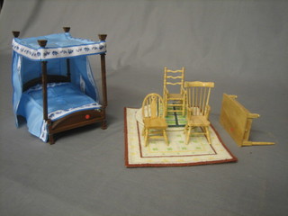 A dolls house 4 poster bed 7", 2 dolls house rugs, a dolls house pine kitchen table fitted a frieze drawer and raised on turned supports 4"  and a dolls house pine kitchen carver chair, a ladder back chair and a wheel back chair