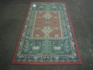 A Wilton machine made Eastern style red and green ground carpet 60" x 32" 