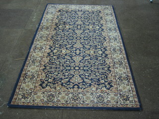 A Persian style blue ground and floral patterned machine made rug 65" x 33"