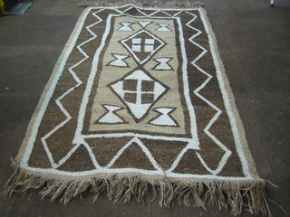 A brown ground Tribal rug  68" x 40"