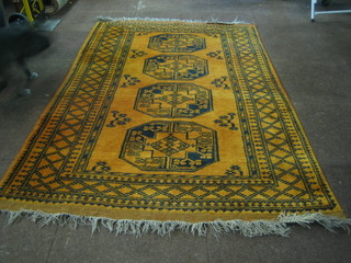 A tan ground Afghan rug with 3 octagons to the centre 76" x 50"