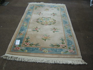 A cream coloured and floral patterned Chinese rug 72" x 37"