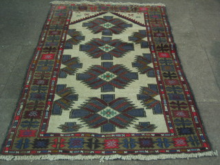 A contemporary beige ground Belouch rug with 4 stylised octagons to the centre, 58" x 31"