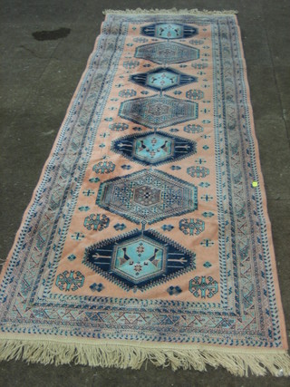 An Eastern style pink ground rug 89" x 28"