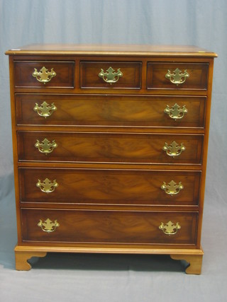 A Georgian style yew chest of 3 short and 4 long drawers with brass swan neck drop handles, raised on bracket feet 39"