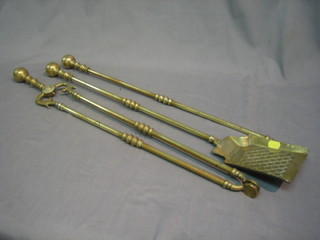 A brass fireside companion set comprising shovel, tongs and poker