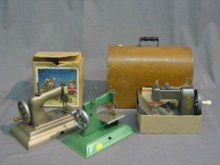 A childs Grain sewing machine, complete with carrying case, a Vulcan sewing machine, a Little Bessie sewing machine and 1 others (5)