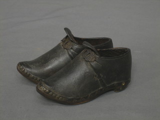 A pair of miniature leather and wooden clogs 5"