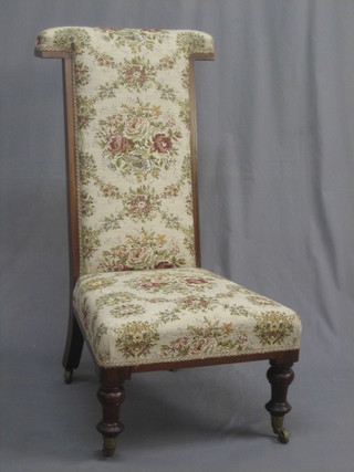 A Victorian rosewood Pre-Dieu chair raised on turned supports