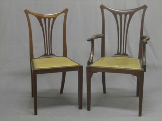 A set of 8 Edwardian Art Nouveau inlaid mahogany dining chairs with pierced vase shaped slat backs, having upholstered seats and raised on tapered supports