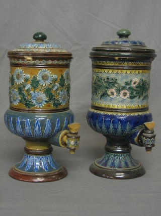 A pair of 19th Century Doulton Lambeth stone glazed water purifiers, with floral decoration and spickets, the base impressed Doulton Lambeth MP and BB, 1 containing original water purifier (both chipped throughout) 13"