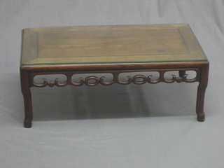 An Oriental rectangular Padouk wood occasional table, raised on tapering supports 30"