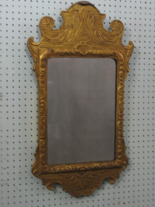 A rectangular Chippendale style mirror contained in a decorative gilt frame 25"