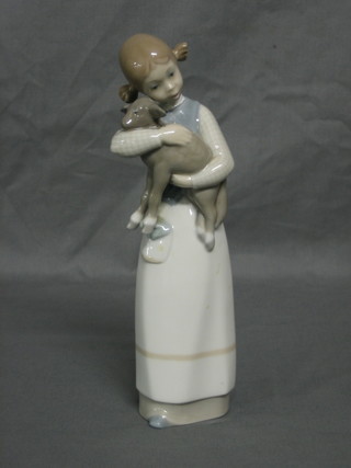 A Lladro figure No 1010 Girl with Lamb 8" (f and r)