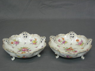 A pair of Dresden circular pierced porcelain bowls with floral decoration, raised on spreading feet, the bases marked Dresden and with gilt rose mark 7 1/2"
