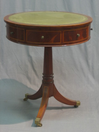 A 20th Century circular mahogany drum table with inset green leather writing surface, fitted 4 drawers and raised on a turned column and tripod base ending in brass caps and castors 24"