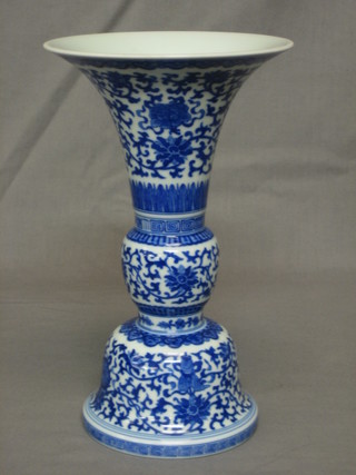 An Oriental blue and white trumpet shaped vase 10"