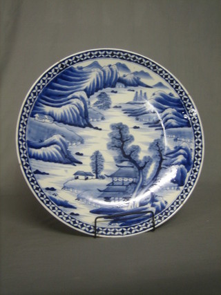 A large 19th Century Oriental blue and white charger decorated landscape 18"