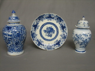 An 18th/19th Century Delft vase and cover 10" (lid f and r), together with a circular Delf plate 9" (some chips) and 1 other urn and cover 9" (lid f and r)