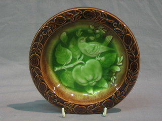 A circular Continental Majolica style bowl decorated birds amidst tree 7"