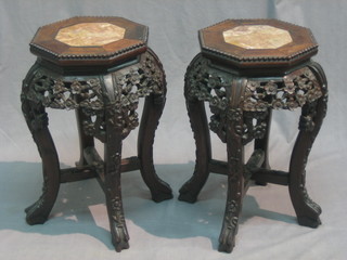 A pair of Oriental Padouk wood octagonal jardiniere stands with pink veined marble tops, raised on cabriole supports 10"
