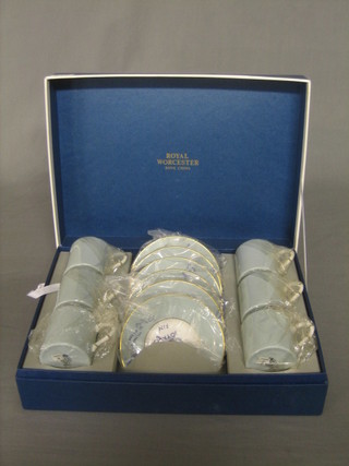 A Royal Worcester 12 piece coffee service, cased together with a pair of Dartington champagne flutes and 2 Stuart cut glass vase, boxed