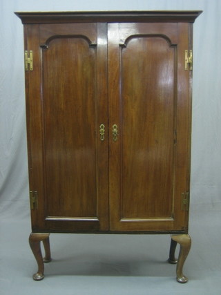 A Georgian mahogany bookcase top with moulded cornice, the interior fitted adjustable shelves, enclosed by arch plate panelled doors, raised on cabriole supports 37"