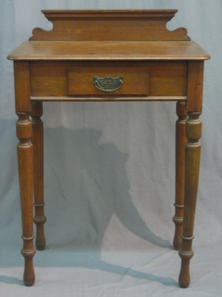 A Victorian oak hall table with raised back fitted a drawer and raised on turned supports 24"