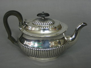 An oval silver plated teapot with demi-reeded decoration