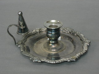 A circular silver plated chamber stick