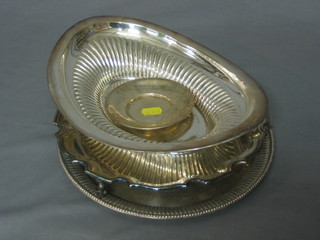 A circular silver plated salver with bracketed border, 2 other plated salvers and a boat shaped basket