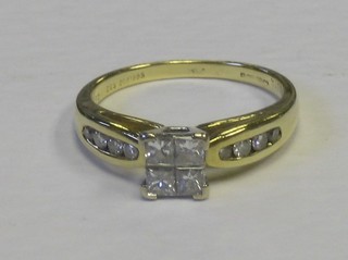 A lady's 18ct gold dress ring set 4 square cut diamonds and 8 diamonds to the shoulders