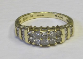 A lady's 18ct gold dress ring set 10 diamonds and with baguette cut diamonds to the shoulders