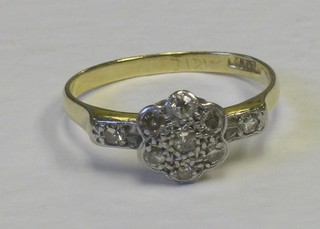 A lady's 18ct gold cluster shaped dress ring, set numerous illusion set diamonds