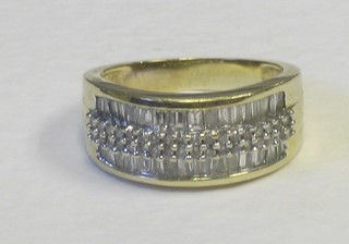A lady's gold dress ring set numerous baguette cut diamonds (approx 1 ct)