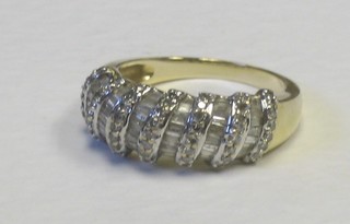 A lady's gold dress ring set round and baguette cut diamonds