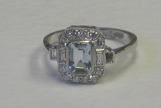 A lady's 18ct white gold dress ring set a rectangular cut aquamarine surrounded by numerous diamonds and 4 baguette cut diamonds to the corners approx 0.50/0.70ct