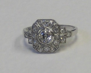 A lady's 18ct white gold Art Deco style dress ring, set a circular diamond supported by numerous diamonds, approx. 0.65ct