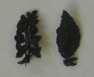 2 jet coloured brooches