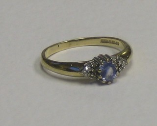 A 9ct gold dress ring set a sapphire surrounded by diamonds