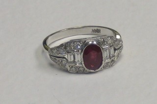 A lady's 18ct white gold dress ring set an oval cut ruby supported by 4 baguette cut diamonds and numerous other diamonds approx 0.50/0.90ct